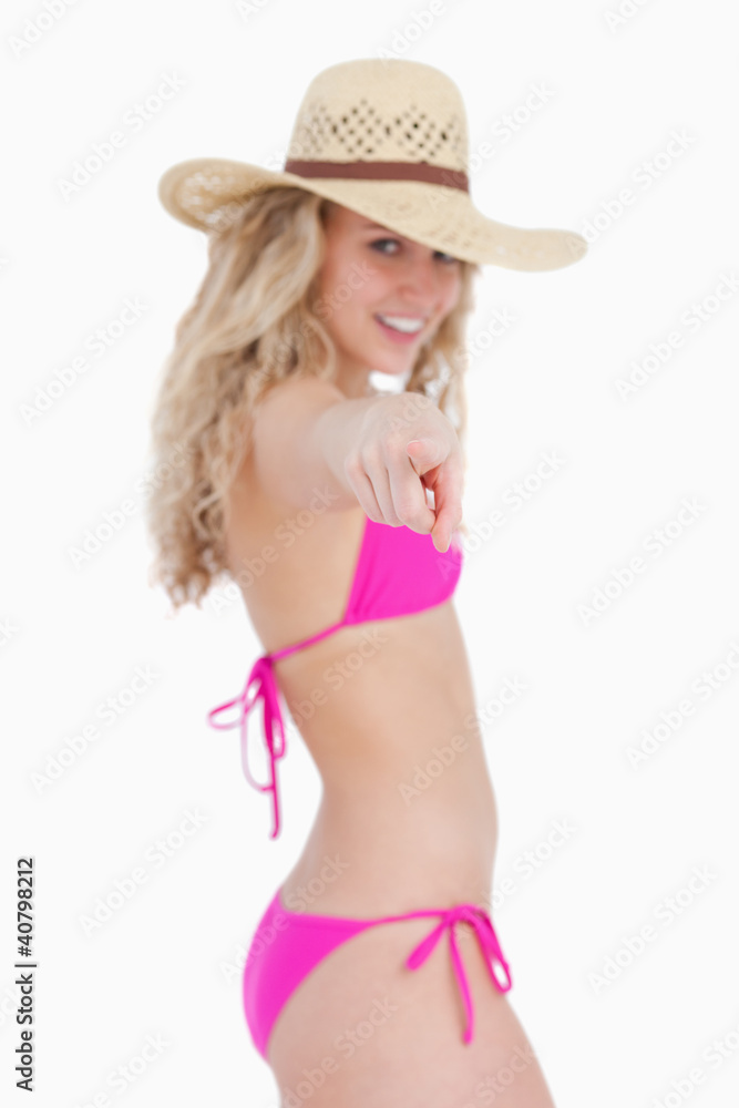 Finger pointed by an attractive teenager in beachwear Finger pointed by an attractive teenager in beachwear