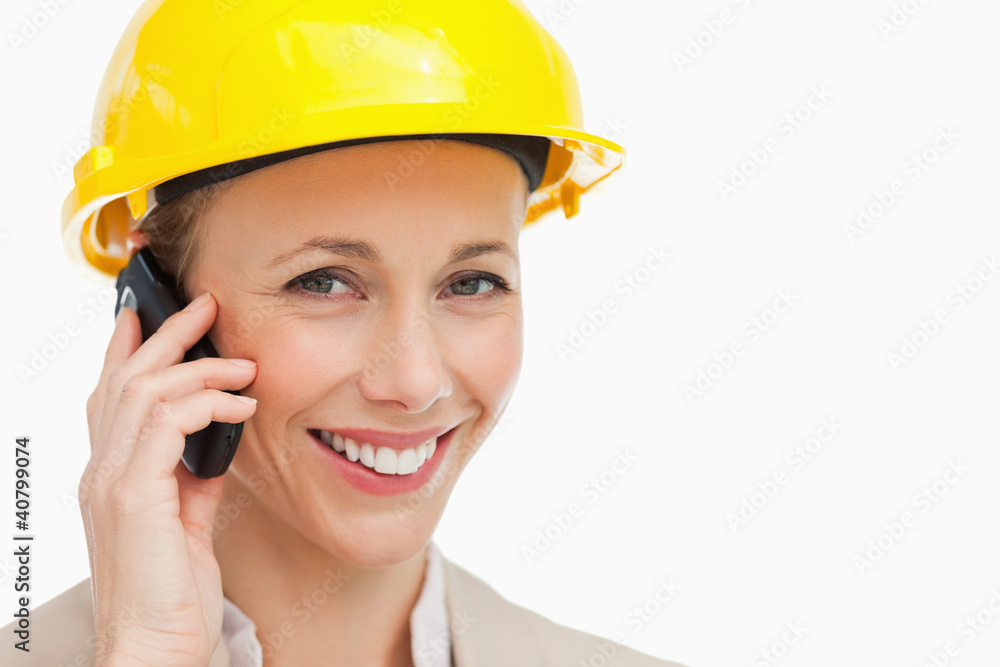 Portrait of a woman wearing safety helmet on the phone Portrait of a woman wearing safety helmet on the phone