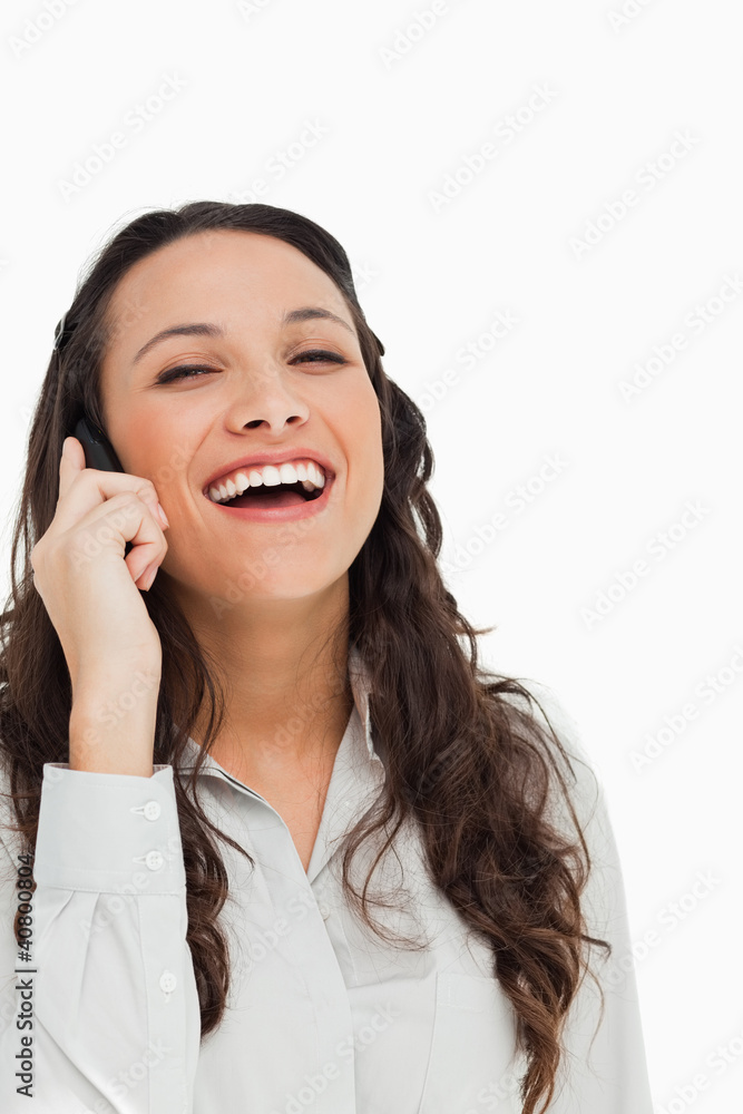 Portrait of a pretty brunette laughing while phoning Portrait of a pretty brunette laughing while phoning