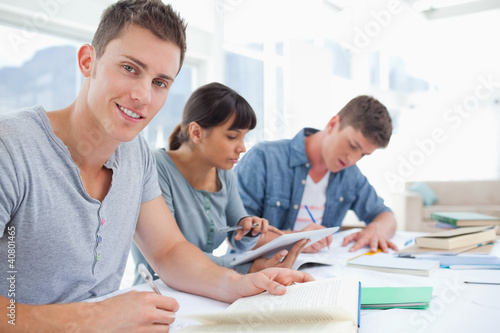 Side view of a group of students as one student looks at the cam