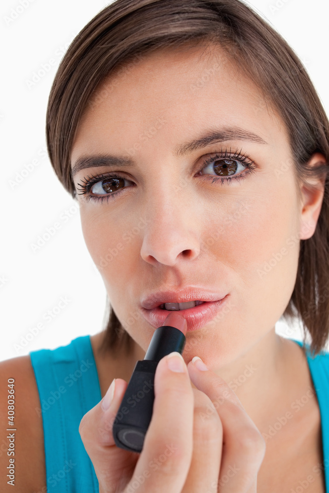 Young woman focused on making-up Young woman focused on making-up