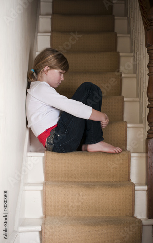 Neglected girl on stairs