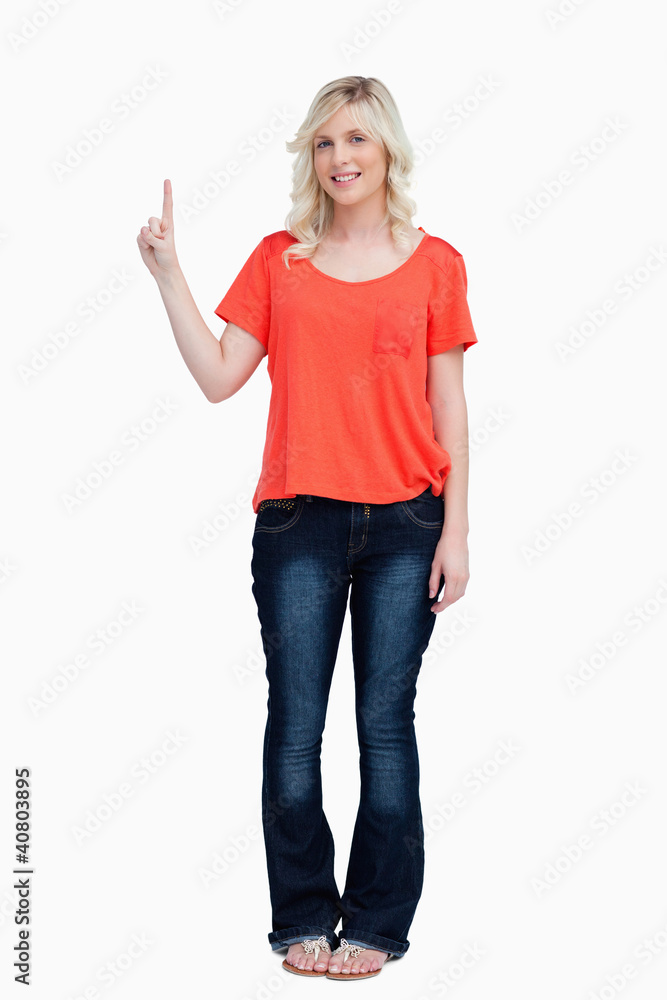 Smiling teenager raising her finger in the air Smiling teenager raising her finger in the air