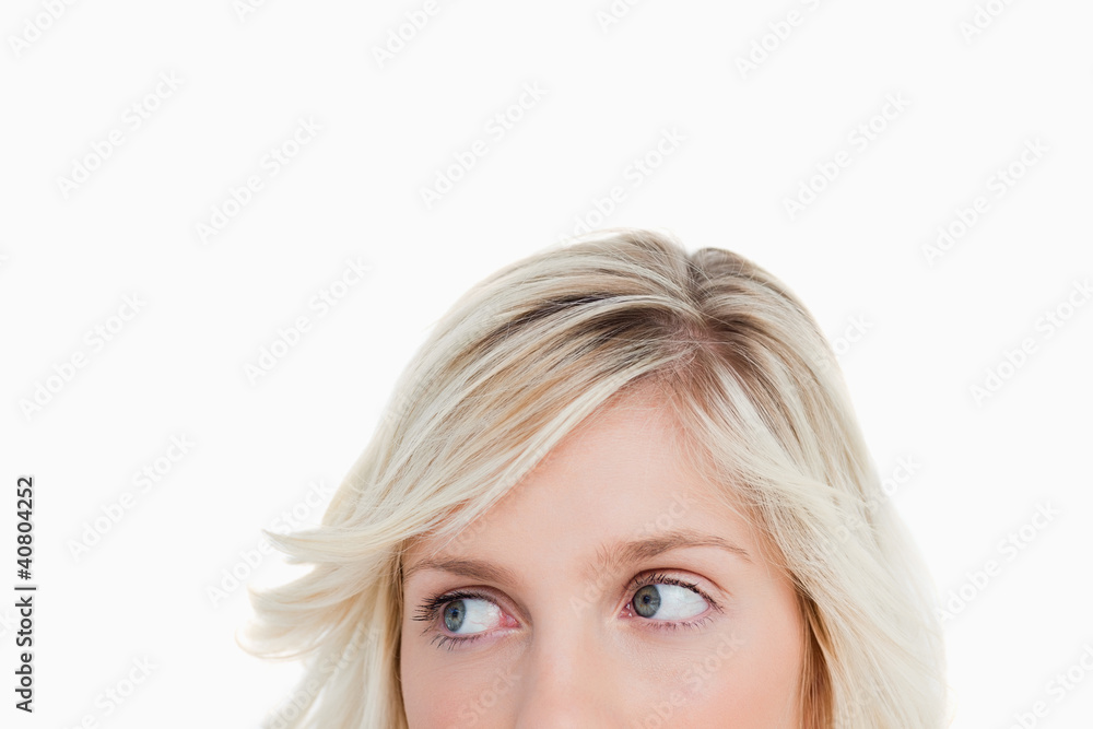 Upper part of a blonde woman face looking on the side Upper part of a blonde woman face looking on the side
