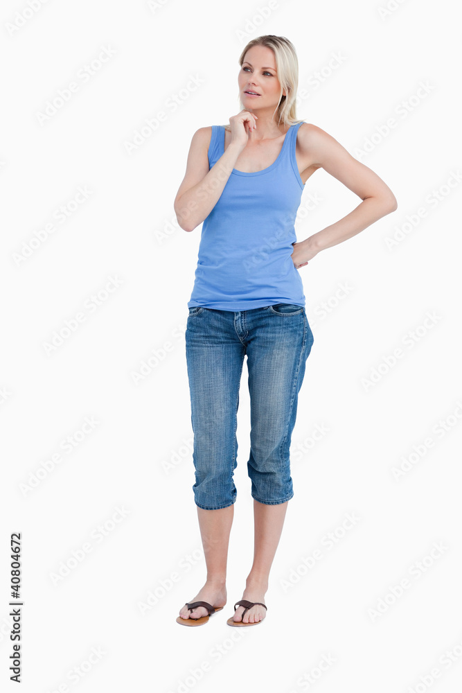 Blonde woman looking on the side while placing her hand on chin Blonde woman looking on the side while placing her hand on chin