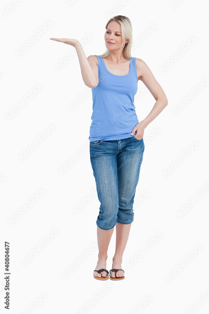 Blonde woman looking at her right hand palm up Blonde woman looking at her right hand palm up