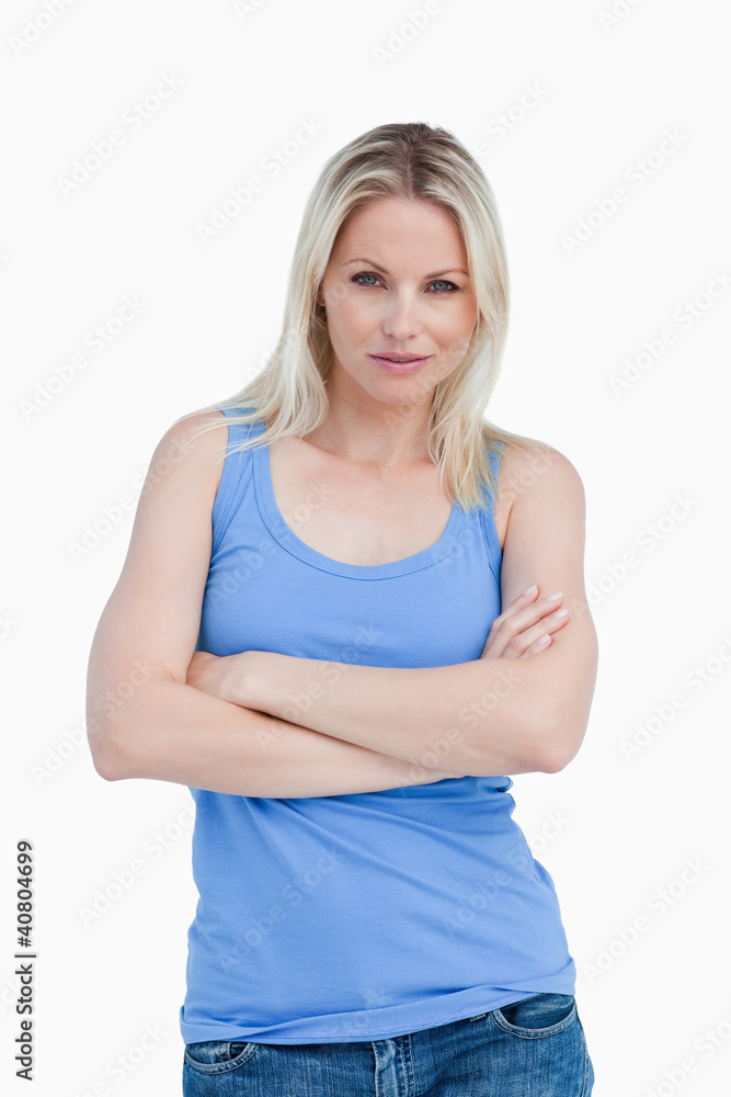 Blonde woman looking straight at the camera with arms crossed Blonde woman looking straight at the camera with arms crossed