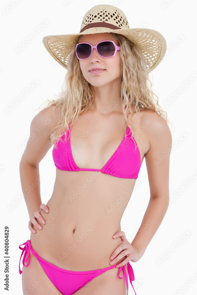 Attractive blonde teenager wearing a swimsuit with a hat and sun Attractive blonde teenager wearing a swimsuit with a hat and sun
