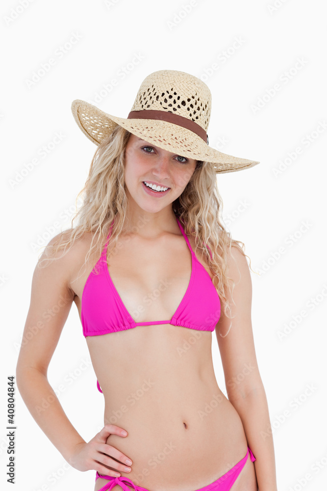 Smiling teenager wearing a pink swimsuit and a hat Smiling teenager wearing a pink swimsuit and a hat