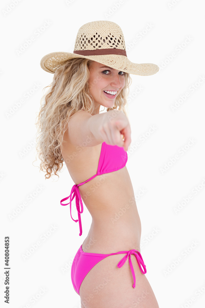 Smiling attractive teenager pointing her finger Smiling attractive teenager pointing her finger
