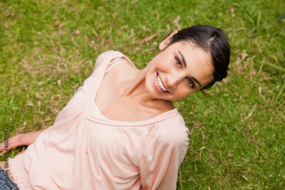 Smiling woman looking upwards while lying down Smiling woman looking upwards while lying down