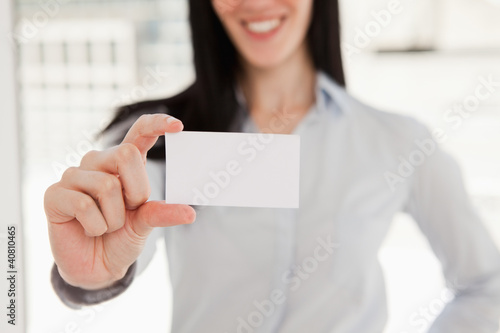 Close up of a business card being held by a woman