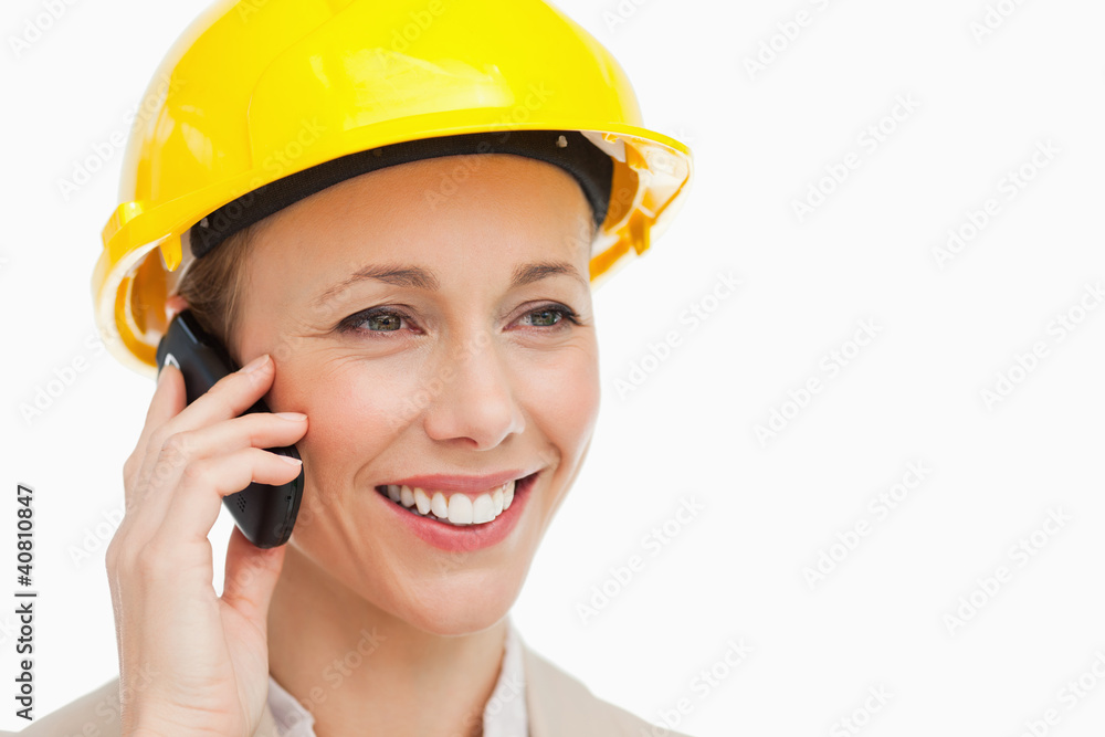 Woman wearing safety helmet on the phone Woman wearing safety helmet on the phone
