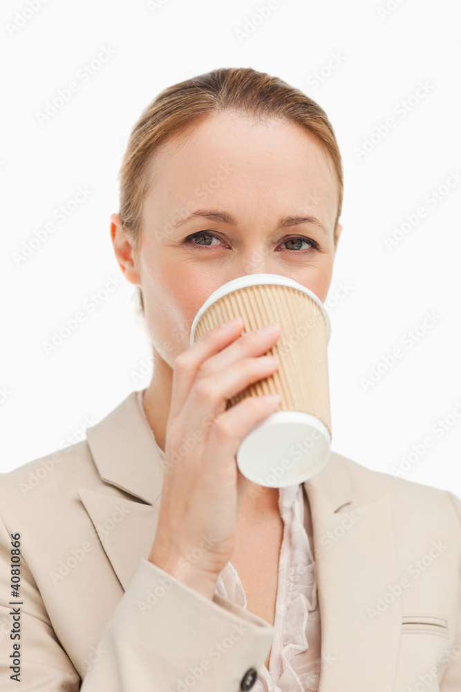 Portrait of a woman in a suit drinking a takeaway coffee Portrait of a woman in a suit drinking a takeaway coffee