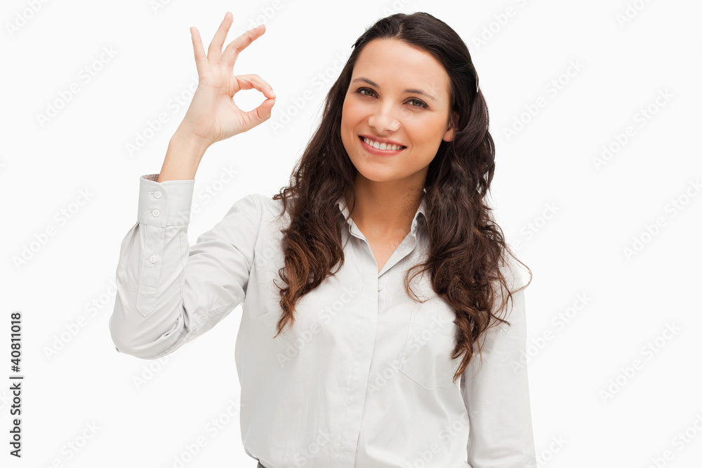 Portrait of a brunette approving with hand Portrait of a brunette approving with hand
