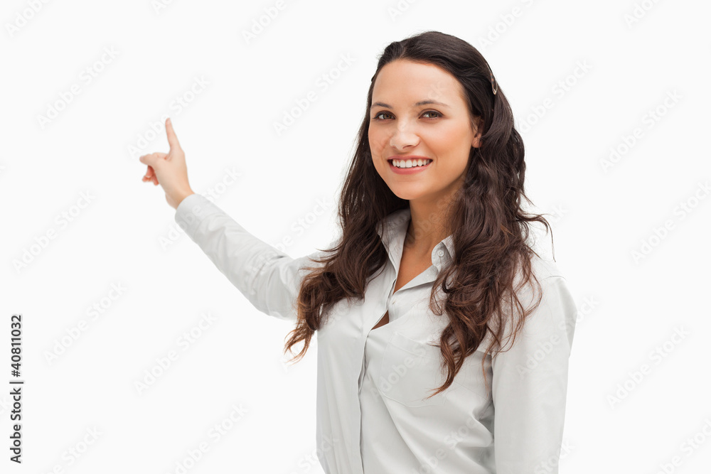 Portrait of a smiling brunette pointing in her back Portrait of a smiling brunette pointing in her back