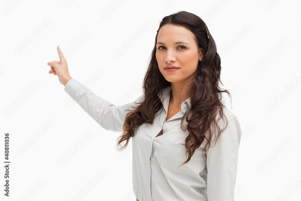 Portrait of a brunette pointing in her back Portrait of a brunette pointing in her back