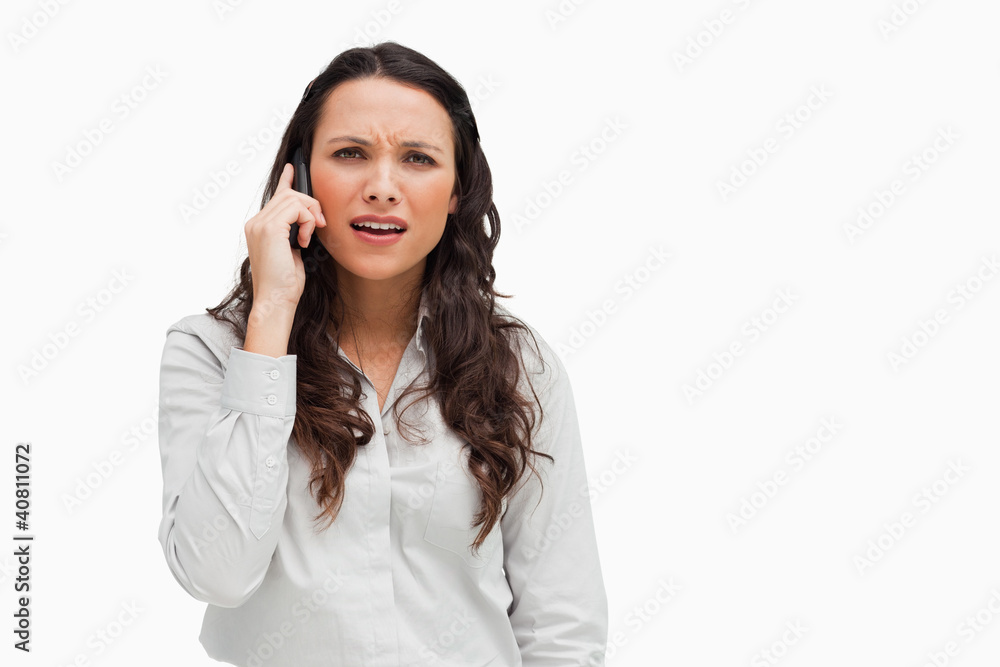 Close-up of a brunette grimacing while phoning Close-up of a brunette grimacing while phoning
