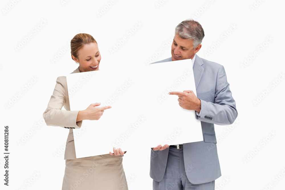 Business people holding and pointing a poster Business people holding and pointing a poster