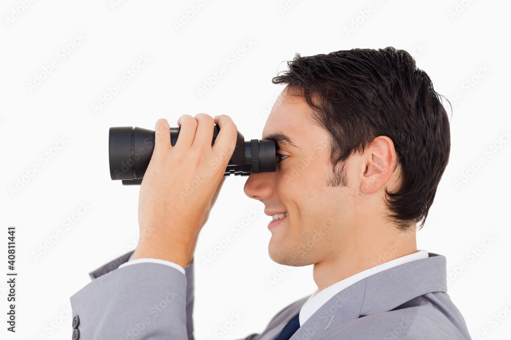 Close-up of a businessman using binoculars Close-up of a businessman using binoculars