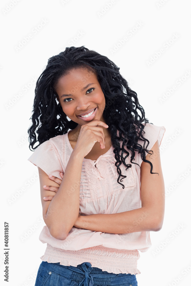 A smiling young woman is looking at the camera A smiling young woman is looking at the camera