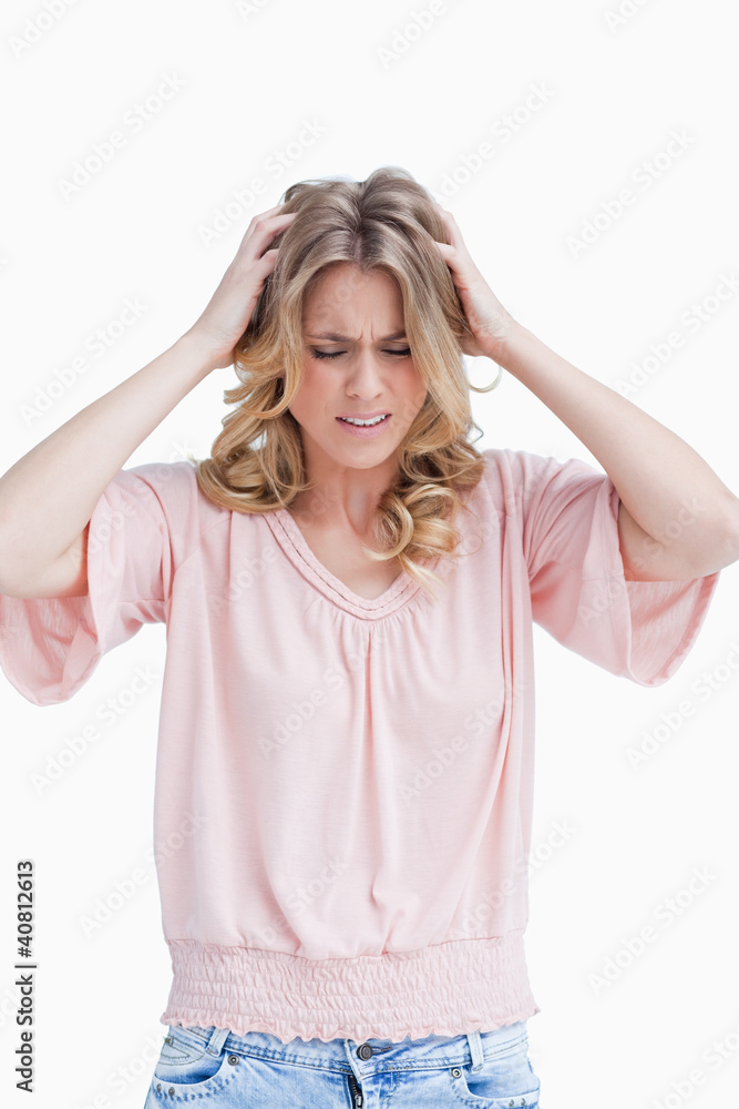 Frustrated woman with her hands in her hair Frustrated woman with her hands in her hair