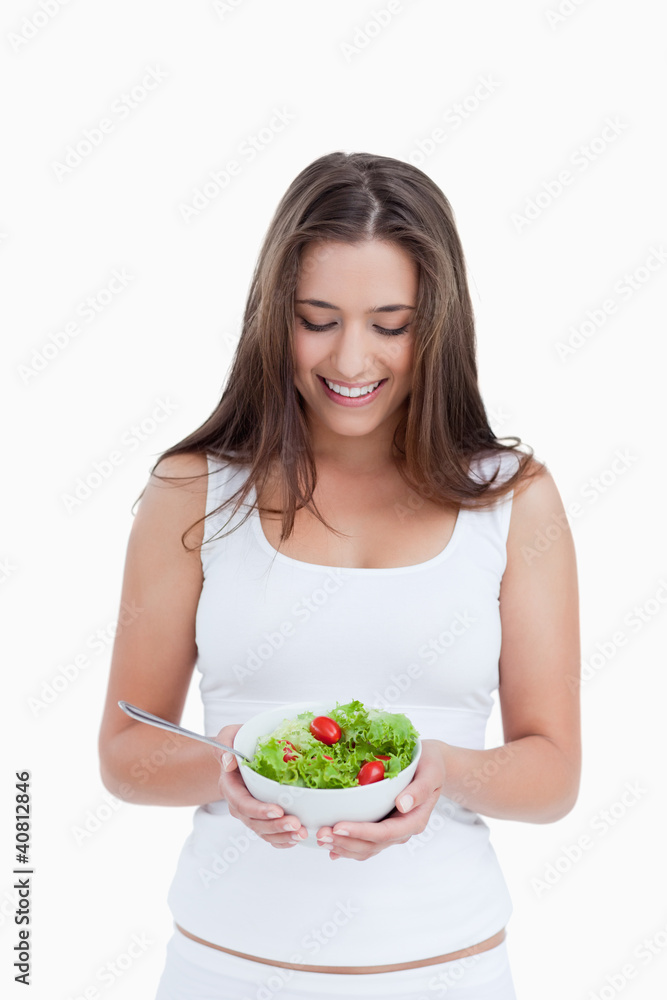 Smiling brunette woman holding a bowl of salad Smiling brunette woman holding a bowl of salad