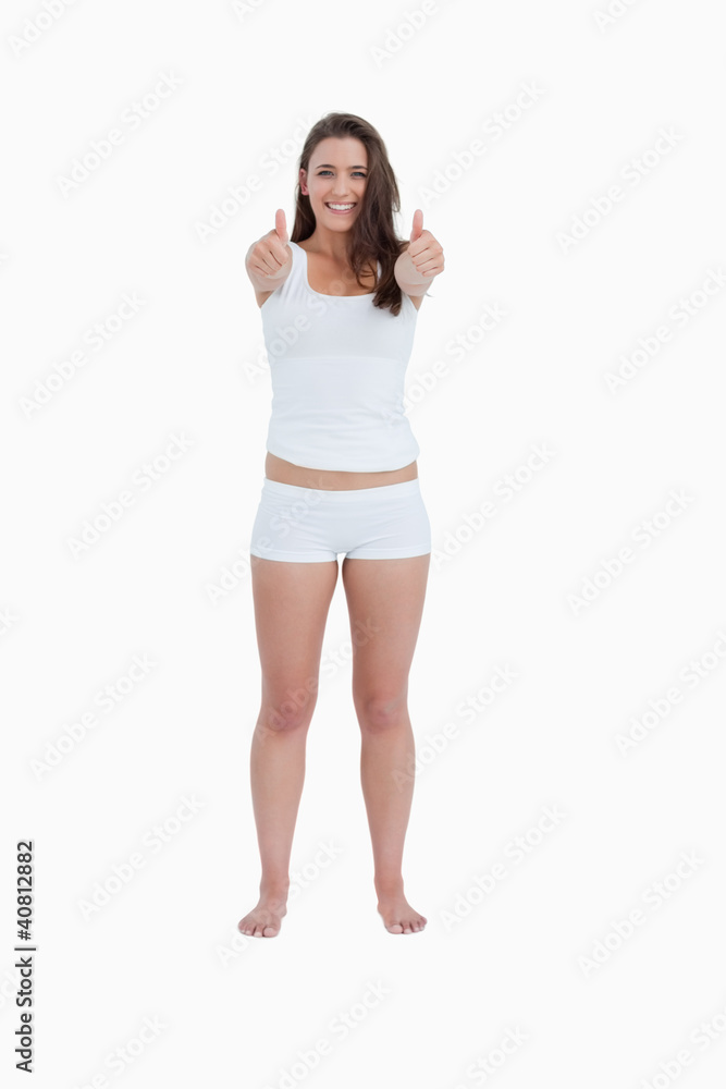 Smiling brunette woman placing her thumbs up Smiling brunette woman placing her thumbs up