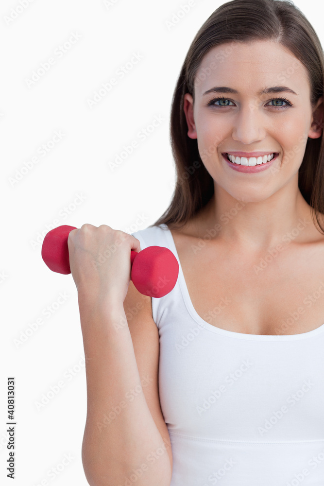 Smiling woman looking at the camera while holding a weight Smiling woman looking at the camera while holding a weight