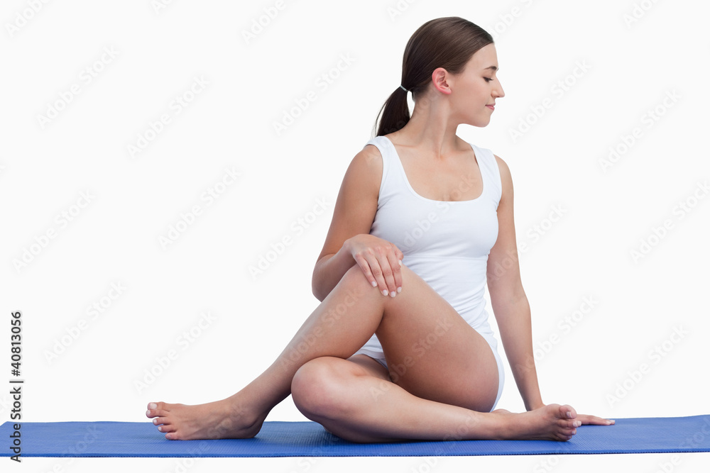 Young woman making exercises on her yoga mat