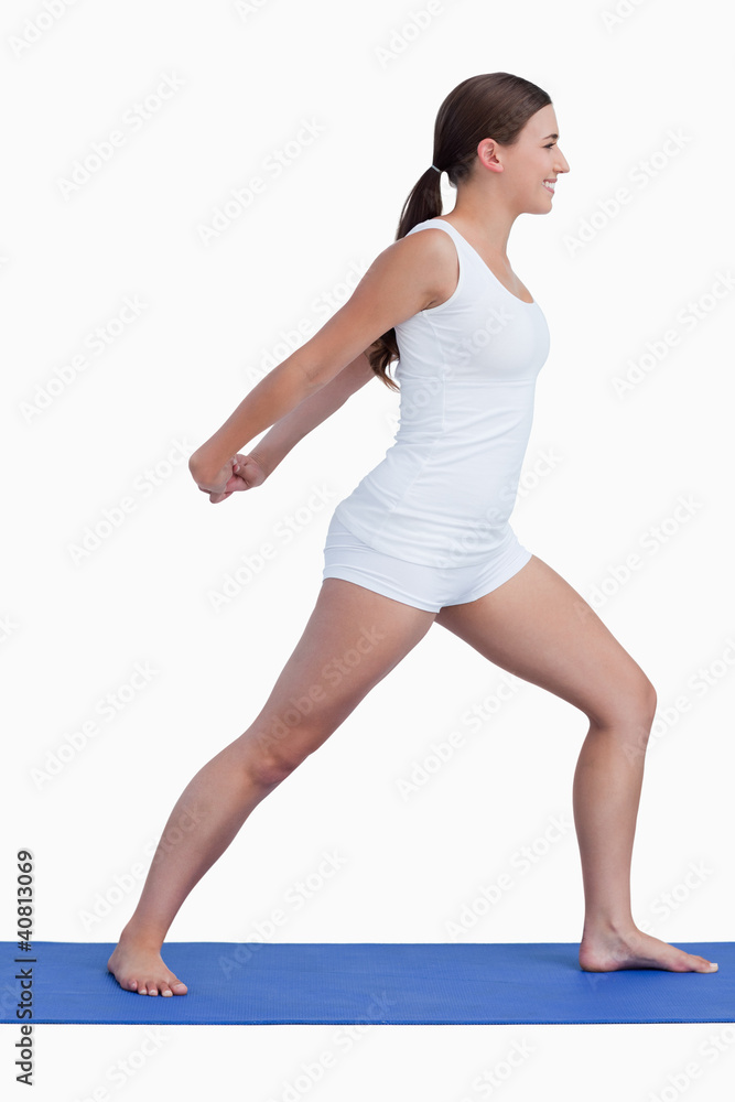 Fototapeta premium Smiling woman stretching her arms while standing upright