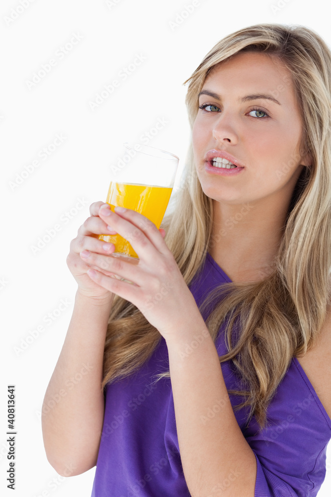 Attractive blonde woman holding an orange juice Attractive blonde woman holding an orange juice