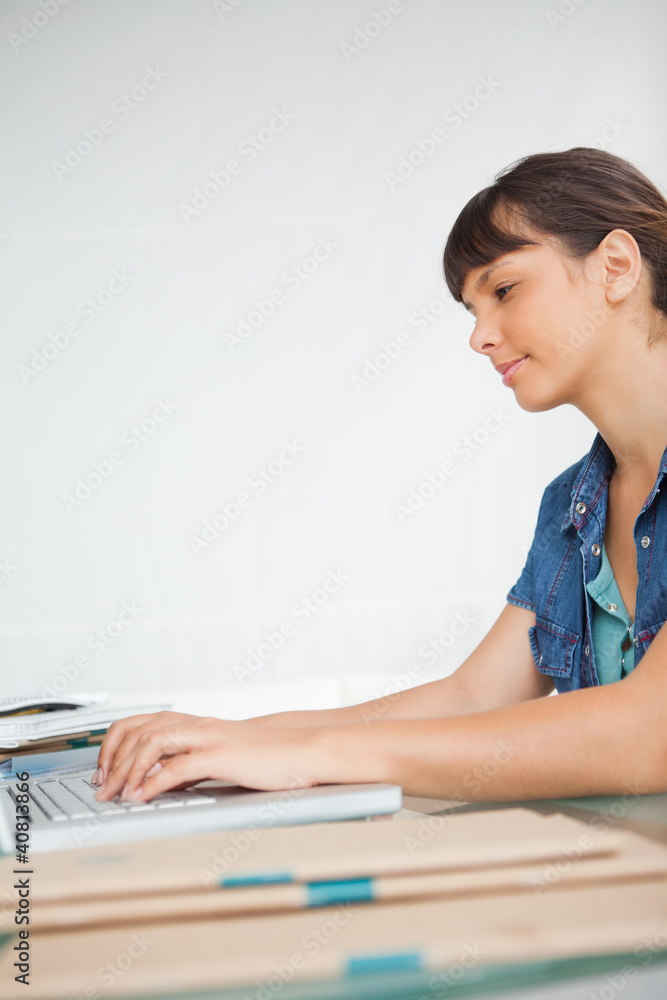 Side view of a smiling student doing her homework Side view of a smiling student doing her homework