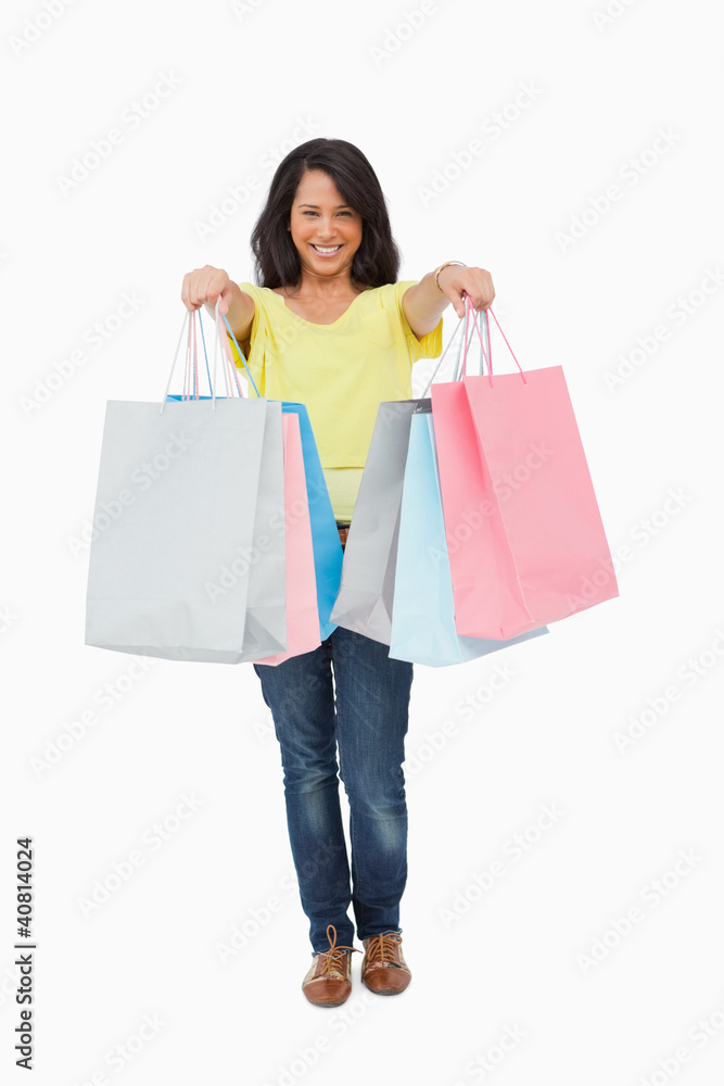 Pretty Latin student showing her shopping bags Pretty Latin student showing her shopping bags
