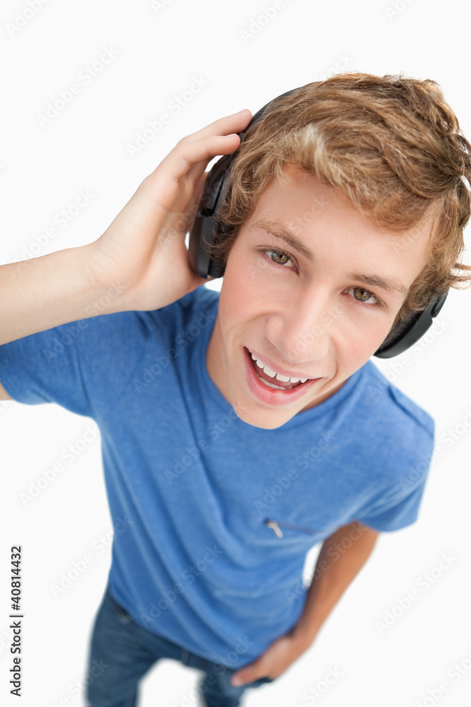 Fisheye view of a blond student wearing headphones Fisheye view of a blond student wearing headphones
