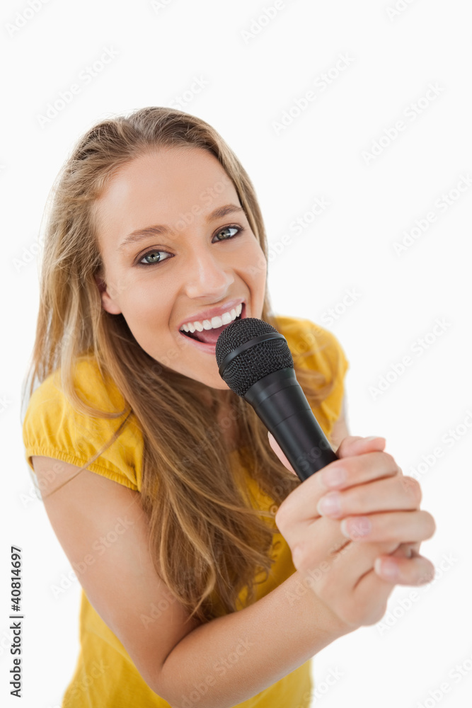 Close-up of a blonde singing with a microphone Close-up of a blonde singing with a microphone