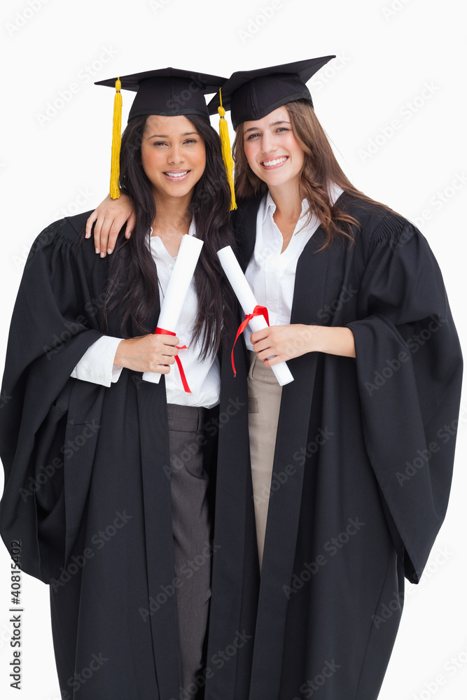 Two women embracing each other after they graduated from univers Two women embracing each other after they graduated from univers