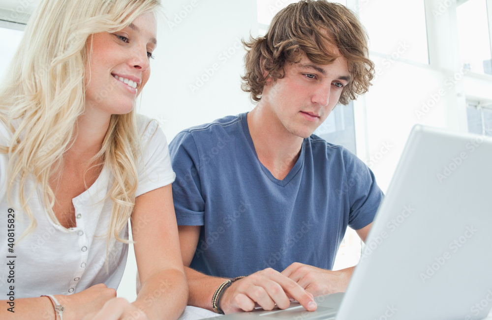 A couple surfing the web on a laptop A couple surfing the web on a laptop
