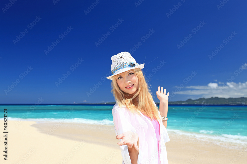 真夏の海辺で遊ぶ笑顔の女性