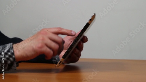 Businessman hands working on tablet computer