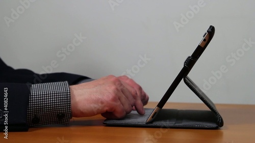 Businessman hands working on tablet with tablet stand
