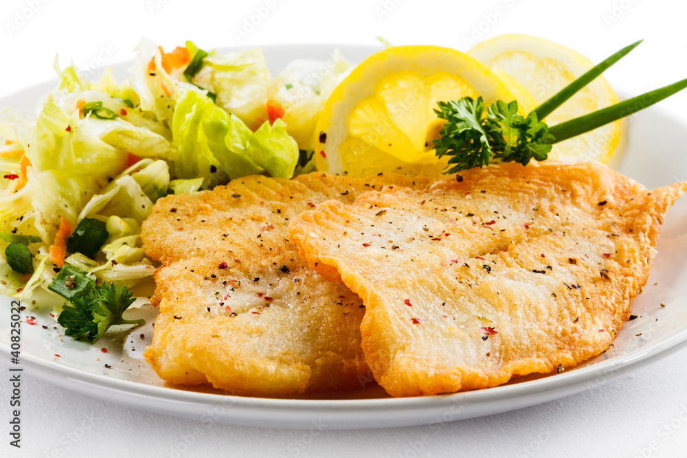Fish dish - fried fish fillets and vegetable salad Fish dish - fried fish fillets and vegetable salad