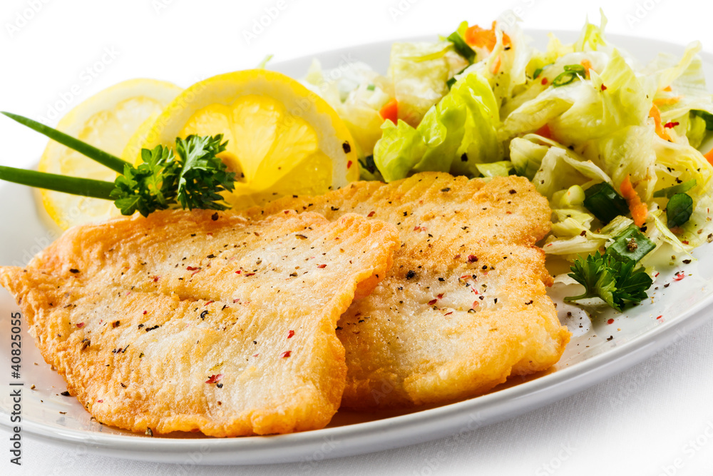 Fish dish - fried fish fillets and vegetable salad Fish dish - fried fish fillets and vegetable salad