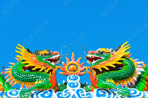 twin chinese dragon statue in blue sky © sundayhill