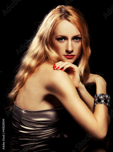 Fashion portrait of sensual young woman on black background