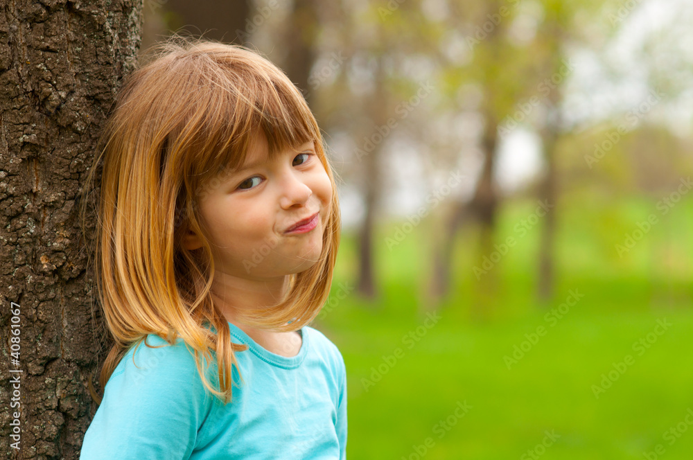 Smiling shy girl posing in the nature on beautifulday Smiling shy girl posing in the nature on beautifulday