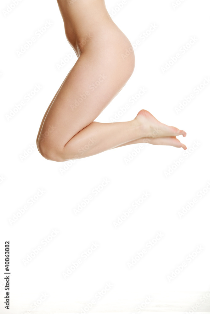 Close up photo of nude legs of young female, isolated on white b Close up photo of nude legs of young female, isolated on white b