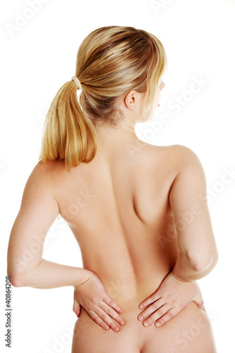 Naked woman heaving back pain, isolated on white background 
