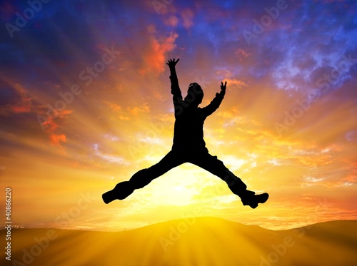 man jumping on a sunset background