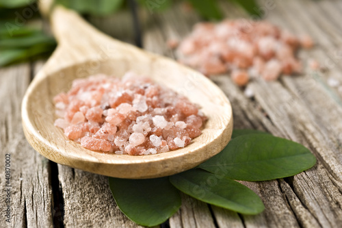 Course pink Himalayan salt on a wooden spoon